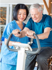 caregiver and elder man having a physical therapy